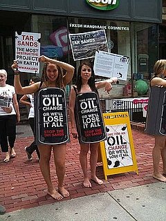 Lush Employees Wear Oil Barrels to Protest Tar Sands