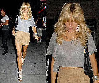 Sienna Miller Wearing Tan Suede Shorts, Gray Cropped Tee, and Buckle Wedges