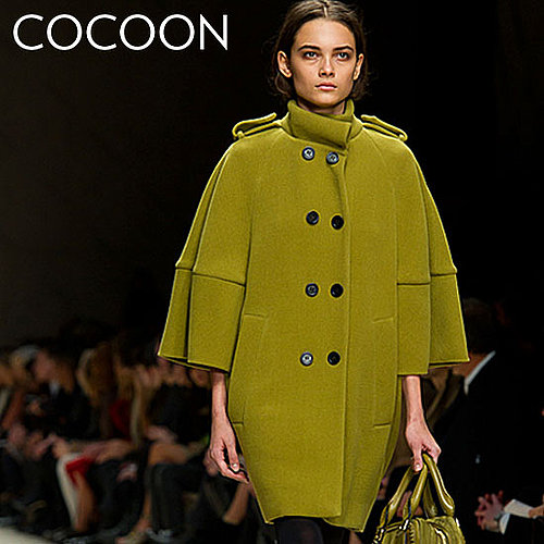 Why we love it: A cocoon coat differentiates itself with a covetable silhouette. We love the chic play on proportion from Fall runways like Burberry.
How to wear it: The cocoon coat is a great way to inject a dose of the on-trend into your Fall wardrobe. Because the shape is such a statement, we recommend pairing it with understated separates, like a great pair of skinny pants for perfect office attire.
Shop the runway:
Burberry Sculptural Wool Cape Coat ($3,595)
Why we love it: A cocoon coat differentiates itself with a covetable silhouette. We love the chic play on proportion from Fall runways like Burberry.
How to wear it: The cocoon coat is a great way to inject a dose of the on-trend into your Fall wardrobe. Because the shape is such a statement, we recommend pairing it with understated separates, like a great pair of skinny pants for perfect office attire.
Shop the runway:
Burberry Sculptural Wool Cape Coat ($3,595)