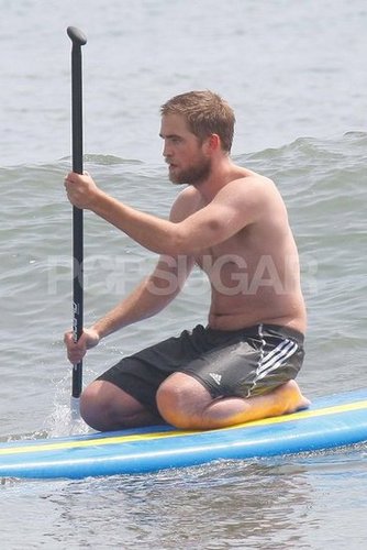 Robert Pattinson sat on a paddleboard.
Robert Pattinson sat on a paddleboard.