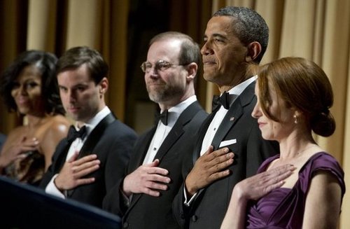 President Obama stood to salute the flag.
President Obama stood to salute the flag.