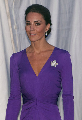 A close-up of the front-cinched detail on her purple Issa dress, as well as her sparkly maple-leaf brooch.
A close-up of the front-cinched detail on her purple Issa dress, as well as her sparkly maple-leaf brooch.