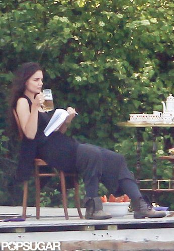 Katie Holmes drank a beer on set while holding a book for a scene.
Katie Holmes drank a beer on set while holding a book for a scene.