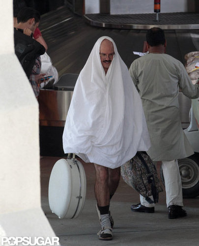 David Cross carried a white hat box.
David Cross carried a white hat box.