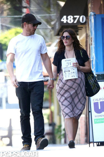 Drew Barrymore held hands with her husband.
Drew Barrymore held hands with her husband.
