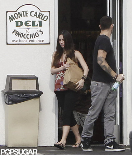 Pregnant Megan Fox carried food out of a deli while Brian Austin Green held the door.
Pregnant Megan Fox carried food out of a deli while Brian Austin Green held the door.