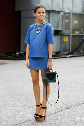 Miroslava Duma charms in a blue skirt-and-top set — with her signature statement jewels and platforms.
Miroslava Duma charms in a blue skirt-and-top set — with her signature statement jewels and platforms.