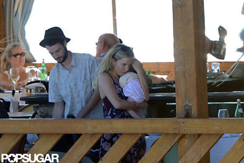 Tom Sturridge watched Sienna Miller hold baby Marlowe.
Tom Sturridge watched Sienna Miller hold baby Marlowe.
