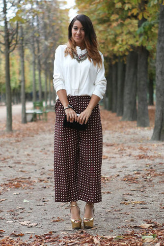 Whimsical dot pants, gold platforms, and statement jewels gave new life to a classic white blouse.
Whimsical dot pants, gold platforms, and statement jewels gave new life to a classic white blouse.