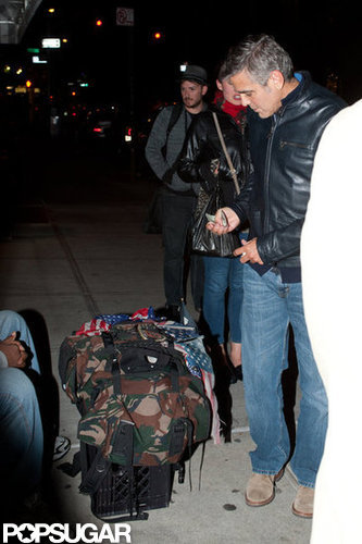 George Clooney gave money to a homeless man in NYC.
George Clooney gave money to a homeless man in NYC.