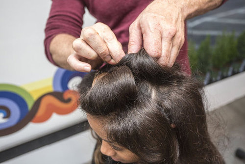 "One thing about textured hair is you can make shapes to get a seamless look," Dickey explained. Starting in the front, take random sections and roll hair around two fingers to form a barrel shape. Secure with bobby pins.
Continue rolling sections (the majority of the curls should be toward the front of the face and bit off center).
"One thing about textured hair is you can make shapes to get a seamless look," Dickey explained. Starting in the front, take random sections and roll hair around two fingers to form a barrel shape. Secure with bobby pins.
Continue rolling sections (the majority of the curls should be toward the front of the face and bit off center).