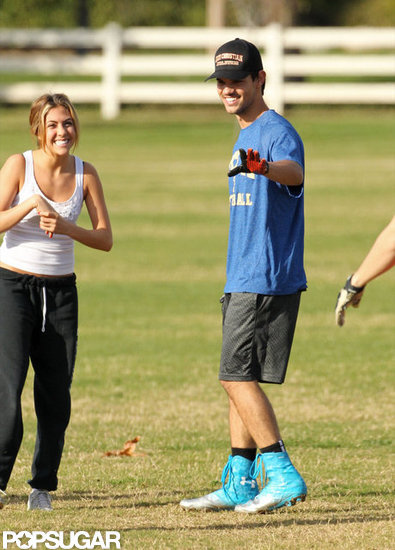 Taylor Lautner played football with a female friend.
Taylor Lautner played football with a female friend.