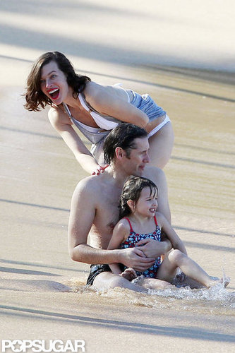 Bikini-Clad Milla Jovovich Poses Beachside With Her Family on NYE Bikini-Clad Milla Jovovich Poses Beachside With Her Family on NYE