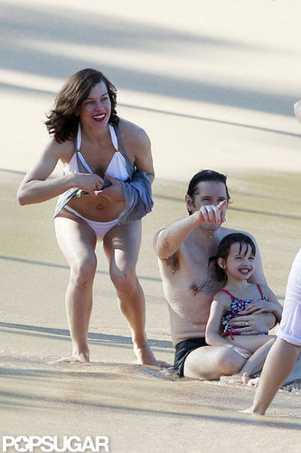 Bikini-Clad Milla Jovovich Poses Beachside With Her Family on NYE Bikini-Clad Milla Jovovich Poses Beachside With Her Family on NYE