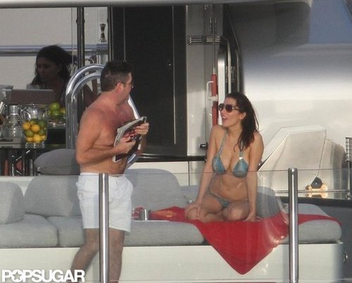 Shirtless Simon Cowell read magazines while Mezhgan Hussainy lounged in a bikini.
Shirtless Simon Cowell read magazines while Mezhgan Hussainy lounged in a bikini.