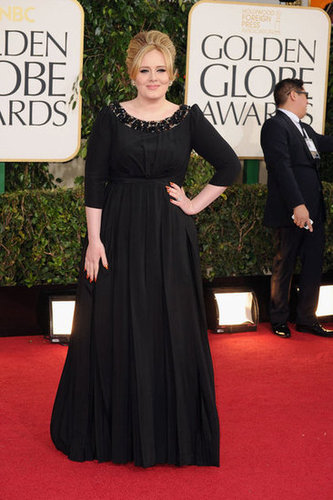 Three months after giving birth to her son, Adele made her postbaby debut wearing a black Burberry gown at the award show.
Three months after giving birth to her son, Adele made her postbaby debut wearing a black Burberry gown at the award show.