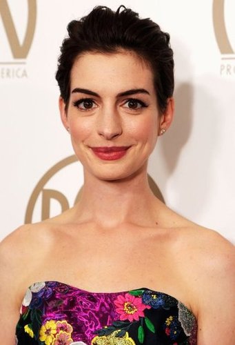 Simple diamond studs and a bold red lip polished off her fun ensemble.
Simple diamond studs and a bold red lip polished off her fun ensemble.