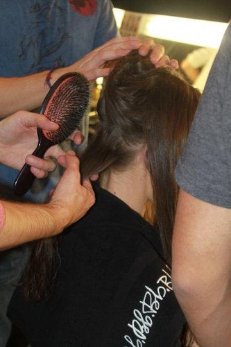Even though his creation was topped with a baseball cap, Laurent Philippon was no less passionate about the hairstyling. He prepped the hair with Bumble and Bumble Full Form Mousse and used fingers to blow-dry.
"We're working the hair with a fairly large curling iron, but we are doing it in a nontraditional way. It's very subtle to create a slight bend with the hair by just caressing the hair with the iron," Philippon explained. After using the curling iron, hair was brushed out to give it a windblown biker look.
Even though his creation was topped with a baseball cap, Laurent Philippon was no less passionate about the hairstyling. He prepped the hair with Bumble and Bumble Full Form Mousse and used fingers to blow-dry.
"We're working the hair with a fairly large curling iron, but we are doing it in a nontraditional way. It's very subtle to create a slight bend with the hair by just caressing the hair with the iron," Philippon explained. After using the curling iron, hair was brushed out to give it a windblown biker look.