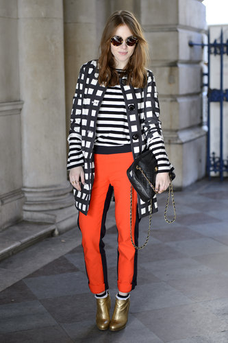 A windowpane-patterned coat added print-on-print play off her stripes and bright pants.
A windowpane-patterned coat added print-on-print play off her stripes and bright pants.