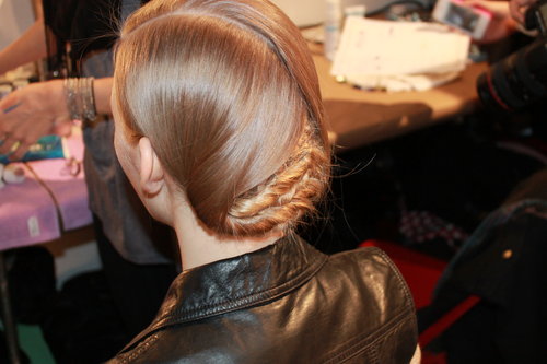 Pecis described the back as "probably being more complicated than it has to be." He started by spraying the hair with a volumizing spray before splitting it into three horizontal sections. He then plaited the bottom sections into cornrows and twisted the two side sections before folding them over for a "curtain-like effect."
Pecis described the back as "probably being more complicated than it has to be." He started by spraying the hair with a volumizing spray before splitting it into three horizontal sections. He then plaited the bottom sections into cornrows and twisted the two side sections before folding them over for a "curtain-like effect."