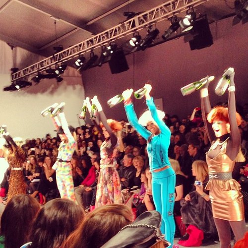 Models exercising with champagne bottles at Betsey Johnson.
Models exercising with champagne bottles at Betsey Johnson.