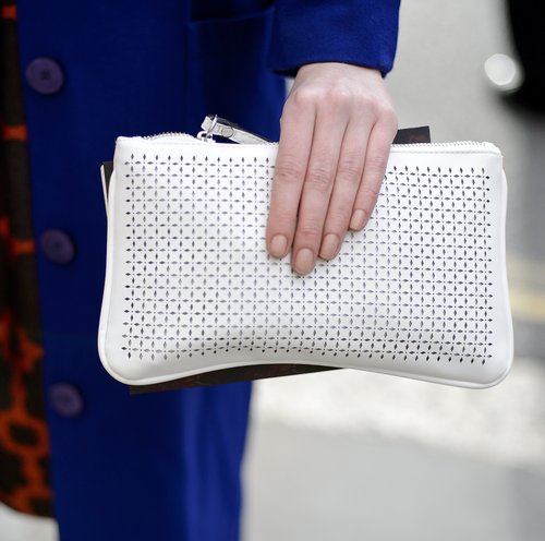 A perforated white clutch added a refreshing Spring touch against a cobalt blue coat.
A perforated white clutch added a refreshing Spring touch against a cobalt blue coat.