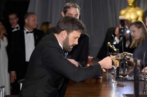Ben Affleck studied his Oscar at the Governors Ball.
Ben Affleck studied his Oscar at the Governors Ball.