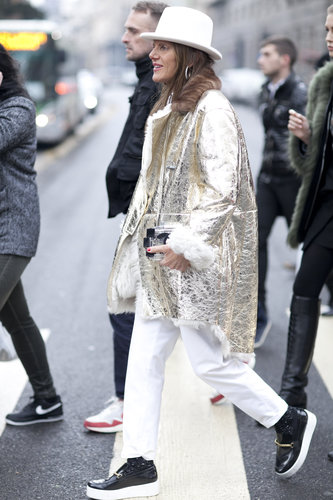 Anna Dello Russo layered up her white pants with a statement-making gold metallic jacket.
Anna Dello Russo layered up her white pants with a statement-making gold metallic jacket.