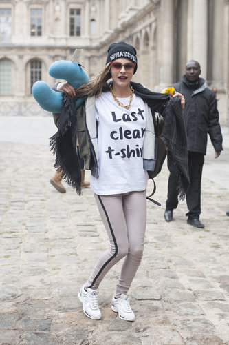 Cara Delevingne wore her "last clean t-shirt" with tuxedo jeans on the streets during Paris Fashion Week.
Cara Delevingne wore her "last clean t-shirt" with tuxedo jeans on the streets during Paris Fashion Week.