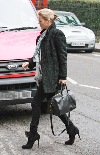 Kate Moss's black fringe booties, Saint Laurent duffle bag and printed scarf were the highlights of her London style.
Kate Moss's black fringe booties, Saint Laurent duffle bag and printed scarf were the highlights of her London style.
