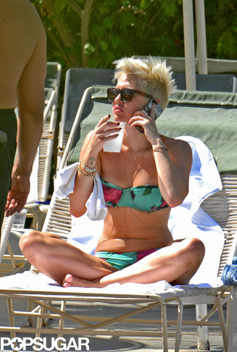 Miley Cyrus sipped on a cold drink poolside.
Miley Cyrus sipped on a cold drink poolside.