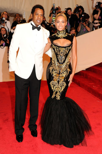 At the 2011 Met Gala in NYC, Beyoncé looked exquisite in a black-and-gold Alexander McQueen gown, while Jay-Z looked sharp in a white tuxedo jacket.
At the 2011 Met Gala in NYC, Beyoncé looked exquisite in a black-and-gold Alexander McQueen gown, while Jay-Z looked sharp in a white tuxedo jacket.