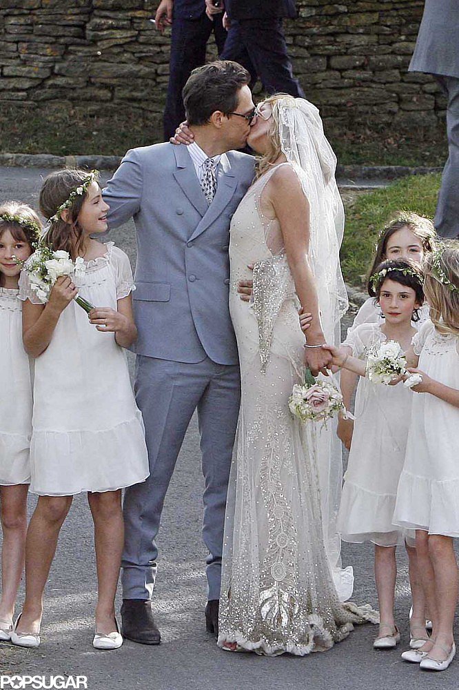 Jamie Hince and supermodel Kate Moss, wearing John Galliano, posed for a kiss following their July 2011 wedding ceremony in England.
Jamie Hince and supermodel Kate Moss, wearing John Galliano, posed for a kiss following their July 2011 wedding ceremony in England.