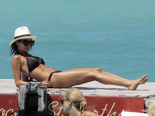 Nicole Richie lounged in St. Barts in April wearing a black triangle bikini, House of Harlow cat-eye sunglasses, and a crisp white fedora.
Nicole Richie lounged in St. Barts in April wearing a black triangle bikini, House of Harlow cat-eye sunglasses, and a crisp white fedora.