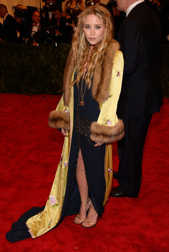 Mary-Kate Olsen layered up in a black studded slit-front Chanel dress and a yellow printed fur-collar coat.
Mary-Kate Olsen layered up in a black studded slit-front Chanel dress and a yellow printed fur-collar coat.