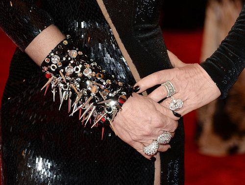Donatella Versace wore a spiked black cuff and diamond rings.
Donatella Versace wore a spiked black cuff and diamond rings.
