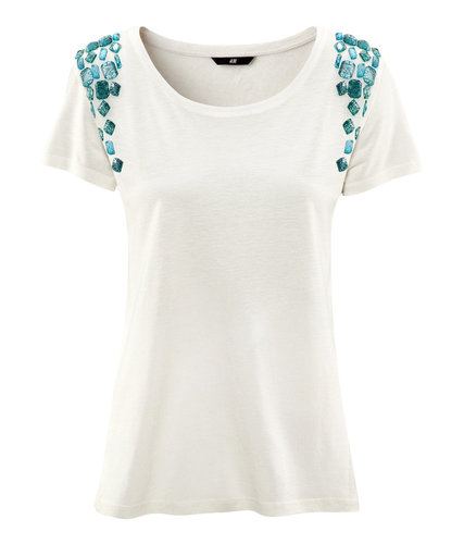 A simple t-shirt with a twist: H&M's Rhinestone-Sleeve Tee ($25) is a great way to dress up a pair of distressed denim.
A simple t-shirt with a twist: H&M's Rhinestone-Sleeve Tee ($25) is a great way to dress up a pair of distressed denim.