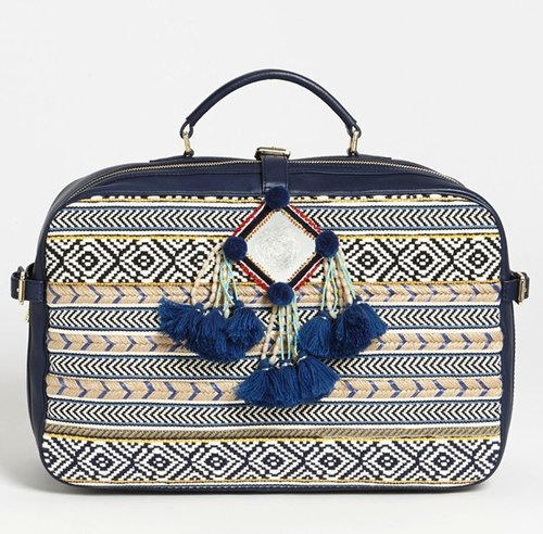 Tory Burch's Priscilla suitcase ($750) is way more structured than a typical weekender bag — but that's why it stands out from the crowd. Oh, and the intricate print and pom-poms help, too.
Tory Burch's Priscilla suitcase ($750) is way more structured than a typical weekender bag — but that's why it stands out from the crowd. Oh, and the intricate print and pom-poms help, too.