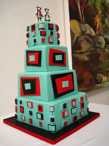 A red, black, and teal geometric stunner is topped off with humorous stick-figure wedding toppers.
Photo by Jeannette Faith
A red, black, and teal geometric stunner is topped off with humorous stick-figure wedding toppers.
Photo by Jeannette Faith