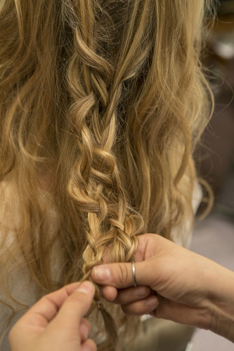 Continue to connect the braid all the way down and secure with another clear elastic. Be sure to also pull at the second braid to create even more texture.
Continue to connect the braid all the way down and secure with another clear elastic. Be sure to also pull at the second braid to create even more texture.