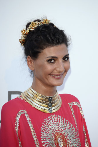 Giovanna Battaglia wore a stacked gold collar and an ornate gold crown.
Giovanna Battaglia wore a stacked gold collar and an ornate gold crown.