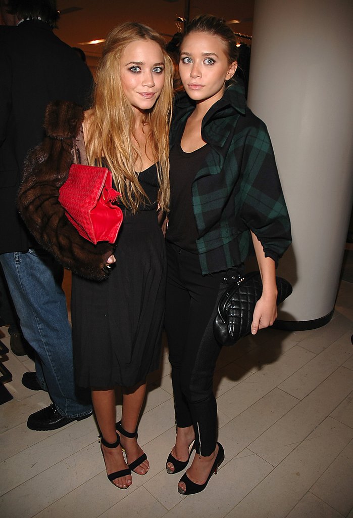 Twinning combo: For Balenciaga's 2006 Paris launch, the girls styled two different but equally chic cropped coats with their black-on-black looks.
Mary-Kate layered a cropped fur topper over her simple black dress while toting an oversize red clutch.
Ashley went preppy in tuxedo-stripe pants and a ruffled tartan coat.
Twinning combo: For Balenciaga's 2006 Paris launch, the girls styled two different but equally chic cropped coats with their black-on-black looks.
Mary-Kate layered a cropped fur topper over her simple black dress while toting an oversize red clutch.
Ashley went preppy in tuxedo-stripe pants and a ruffled tartan coat.