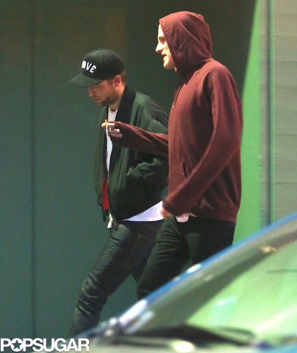 Robert Pattinson and a friend smoked cigarettes.
Robert Pattinson and a friend smoked cigarettes.