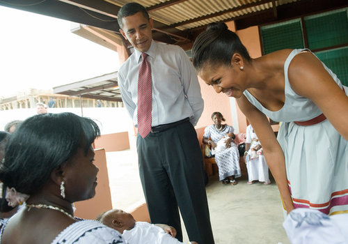 First Lady Michelle Obama smiled at a baby during a July 2009 hospital visit in Ghana.
First Lady Michelle Obama smiled at a baby during a July 2009 hospital visit in Ghana.