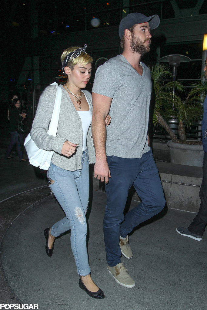 Miley Cyrus held on to her fiancé, Liam Hemsworth, for a movie date in LA. Miley Cyrus held on to her fiancé, Liam Hemsworth, for a movie date in LA.