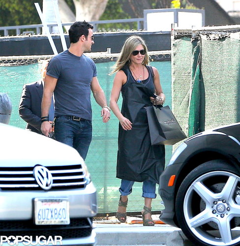 Jennifer Aniston carried a shopping bag and a garment bag.
Jennifer Aniston carried a shopping bag and a garment bag.
