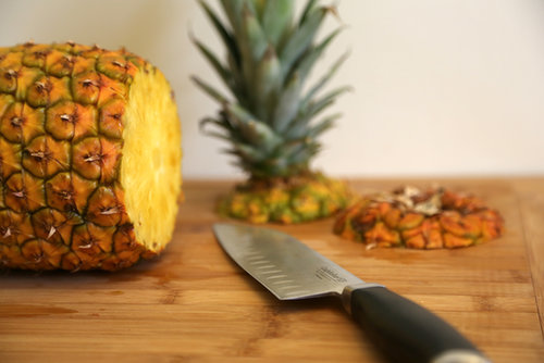 Rotate the pineapple and cut off the bottom. This way, the pineapple can stand up on either end.
Rotate the pineapple and cut off the bottom. This way, the pineapple can stand up on either end.