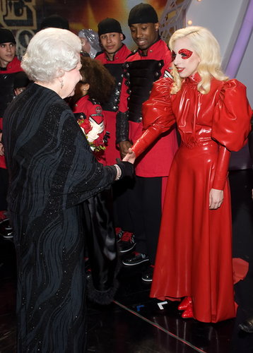 To meet Queen Elizabeth, Lady Gaga opted for a Victorian-inspired red leather dress with a high collar — and sparkling eye makeup to match.
To meet Queen Elizabeth, Lady Gaga opted for a Victorian-inspired red leather dress with a high collar — and sparkling eye makeup to match.
