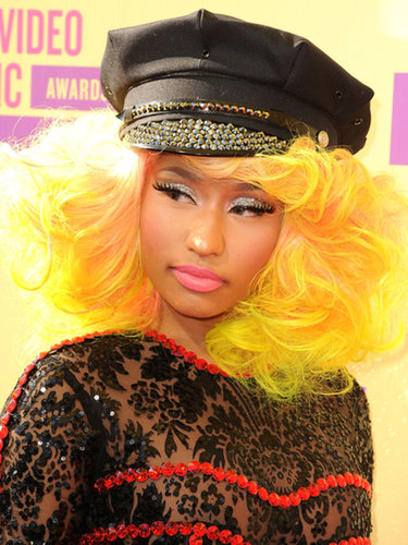 Nicki Minaj never disappoints with extreme red carpet looks, and at the 2012 VMAs she wore a sunshine yellow hairpiece and her signature bubblegum lipstick.
Nicki Minaj never disappoints with extreme red carpet looks, and at the 2012 VMAs she wore a sunshine yellow hairpiece and her signature bubblegum lipstick.