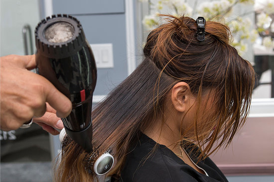 Use a round brush to straighten your strands. "The tension of the round brush will smooth out even curly hair types," Pipino says.
Use a round brush to straighten your strands. "The tension of the round brush will smooth out even curly hair types," Pipino says.